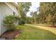 Landscaped side yard with grassy area and shrubs at 105 Tranquility Dr, Villa Rica, GA 30180