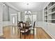 Sunlit dining room with hardwood floors, built-in shelving, and a view of the entryway at 684 Brooks Woolsey Rd, Brooks, GA 30205