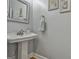 Small powder room with pedestal sink and mirror at 684 Brooks Woolsey Rd, Brooks, GA 30205