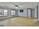 Bright basement recreation room, featuring wood-look floors and a mounted TV at 684 Brooks Woolsey Rd, Brooks, GA 30205