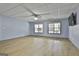 Finished basement recreation room with ceiling fan and large windows at 684 Brooks Woolsey Rd, Brooks, GA 30205