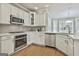 Spacious kitchen with white cabinets, stainless steel appliances, and corner sink at 684 Brooks Woolsey Rd, Brooks, GA 30205