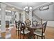 Formal dining room featuring a large table, hardwood floors, and access to the living room at 684 Brooks Woolsey Rd, Brooks, GA 30205