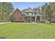 Brick house with a large front yard and mature trees at 684 Brooks Woolsey Rd, Brooks, GA 30205