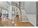 Bright entryway with hardwood floors, elegant staircase, and views into the living room at 684 Brooks Woolsey Rd, Brooks, GA 30205