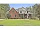 Brick house with landscaped yard and large front porch at 684 Brooks Woolsey Rd, Brooks, GA 30205