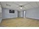Spacious basement recreation room with wood-look floors and multiple doors at 684 Brooks Woolsey Rd, Brooks, GA 30205