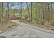 Gravel driveway leading to a brick house with landscaping at 684 Brooks Woolsey Rd, Brooks, GA 30205