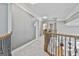 Upstairs hallway with neutral carpeting and access to bedrooms at 684 Brooks Woolsey Rd, Brooks, GA 30205