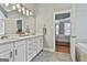 Bright bathroom with double vanity and view into bedroom at 684 Brooks Woolsey Rd, Brooks, GA 30205