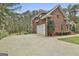 Brick home with a two-car garage and side driveway at 684 Brooks Woolsey Rd, Brooks, GA 30205