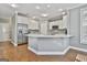 Island kitchen with stainless steel appliances and hardwood floors at 684 Brooks Woolsey Rd, Brooks, GA 30205