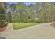 Landscaped yard with a spacious driveway and lush greenery at 684 Brooks Woolsey Rd, Brooks, GA 30205