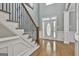 Spacious entryway with hardwood floors, an elegant staircase, and a decorative front door at 684 Brooks Woolsey Rd, Brooks, GA 30205