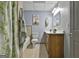 Basement bathroom with shower/tub combo, double vanity, and wood cabinets at 684 Brooks Woolsey Rd, Brooks, GA 30205