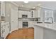 Updated kitchen with white cabinets, stainless steel appliances, and ample counter space at 684 Brooks Woolsey Rd, Brooks, GA 30205