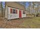 Free-standing storage shed with red door and shutters at 684 Brooks Woolsey Rd, Brooks, GA 30205