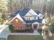 Two-story brick house with a large front porch and attached garage at 684 Brooks Woolsey Rd, Brooks, GA 30205