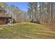 Wooded backyard with expansive lawn and home at 684 Brooks Woolsey Rd, Brooks, GA 30205