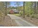 House with a long driveway and beautiful landscaping at 684 Brooks Woolsey Rd, Brooks, GA 30205