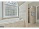Relaxing bathroom with soaking tub and walk-in shower, natural light at 684 Brooks Woolsey Rd, Brooks, GA 30205