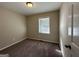 Well-lit bedroom featuring carpet flooring and window blinds at 1154 Penn Ct, Atlanta, GA 30315