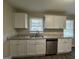 Modern kitchen with white cabinets, granite countertops, and stainless steel appliances at 2150 Macon Se Dr, Atlanta, GA 30315
