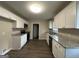 Updated kitchen boasts white cabinets, granite countertops, and stainless steel appliances at 2150 Macon Se Dr, Atlanta, GA 30315