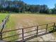 Riding arena with a rustic fence at 7866 Hwy 54, Sharpsburg, GA 30277