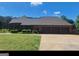 Brick ranch home with three-car garage and landscaped yard at 7866 Hwy 54, Sharpsburg, GA 30277