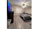 Spacious bedroom with large bed, TV, and gray flooring at 2628 Haligan Pointe, Riverdale, GA 30296