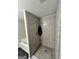 Stand-up shower with modern gray tile at 2628 Haligan Pointe, Riverdale, GA 30296