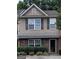 Two-story townhome with stone accents and landscaping at 2628 Haligan Pointe, Riverdale, GA 30296