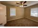 Well-lit bedroom with neutral carpeting and ceiling fan at 1581 Hollyhock Ter, Decatur, GA 30032