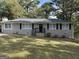 Brick ranch house with dark shutters and lawn at 1581 Hollyhock Ter, Decatur, GA 30032