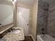 Updated bathroom with granite vanity and marble-tiled shower/tub combo at 1581 Hollyhock Ter, Decatur, GA 30032