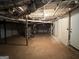 Unfinished basement with exposed utilities and concrete floor at 2019 W Flat Shoals Ter, Decatur, GA 30034