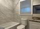Clean bathroom with marble tile and granite vanity at 2019 W Flat Shoals Ter, Decatur, GA 30034