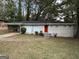 Ranch-style home with white brick exterior, landscaped lawn, and a red front door at 1370 David Cir, Decatur, GA 30032