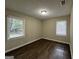 Well-lit bedroom with neutral walls and dark laminate wood flooring at 1370 David Cir, Decatur, GA 30032