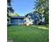 Spacious backyard with grassy area and blue house at 6091 Katherine Rd, Rex, GA 30273