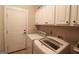 Bright laundry room with washer, dryer, and ample cabinetry at 900 Eskew Rd, Mcdonough, GA 30252