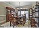 Dining room with wood table, hutch, and shelving at 105 St Albans Way, Peachtree City, GA 30269