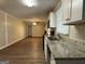 Open kitchen with granite counters and view to living room at 3617 Collins Dr, Douglasville, GA 30135