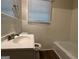 Clean bathroom with white tile and a tub at 3617 Collins Dr, Douglasville, GA 30135
