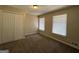 Bedroom with double-door closet and two windows at 3617 Collins Dr, Douglasville, GA 30135