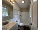 Clean bathroom with white tiled walls and granite vanity at 6358 Joanna St, Lithia Springs, GA 30122