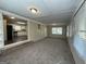 Bright sunroom with carpeted floor and kitchen view at 6358 Joanna St, Lithia Springs, GA 30122
