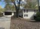 Brick ranch home with carport and large tree in front at 6358 Joanna St, Lithia Springs, GA 30122