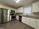 Updated kitchen with stainless steel appliances and granite countertops at 6358 Joanna St, Lithia Springs, GA 30122
